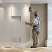 998d7c5c-d747-4ffe-b9f8-3d96008580a2-plasterboard-worker-installs-plasterboard-wall-kitchen-cabinets.jpg